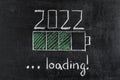 Battery loading indicator showing 2022 loading drawn on chalkboard Royalty Free Stock Photo