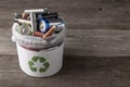 Battery recycle bin with old element on wood table