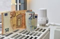Battery with thermostat and paper euro bills Royalty Free Stock Photo