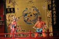 The battle, Beijing Opera, on the stage a male warrior and female warrior in bright traditional clothes.