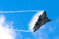 Battle fighter jet flying dives breaking clouds on a blue sky disruption of air flow