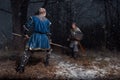 The battle between medieval knights in the style of Game of Thrones in winter forest landscapes. Spear against sword