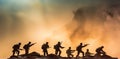 Battle scene. Military silhouettes fighting scene on war fog sky background. Plastic toy soldiers with guns take prisoner the