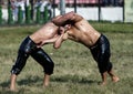 A battle between two wrestlers at the Kirkpinar Turkish Oil Wrestling Festival at Edirne in Turkey. Royalty Free Stock Photo