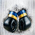 Battle-weary boxing gloves on wooden background Royalty Free Stock Photo