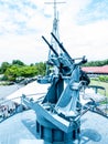 Battleship machine gun against a blue cloudy sky Royalty Free Stock Photo