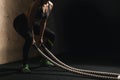 Battling ropes girl at gym workout exercise fitted body Royalty Free Stock Photo