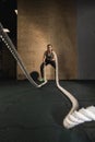 Battling ropes girl at gym workout exercise fitted body Royalty Free Stock Photo