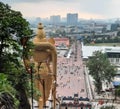 Back view from golden statue Ganesha with view through long way stairs and corporate buildings from the city in background