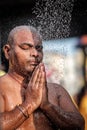 Close-up of men devotee having shower ritual in Thaipusam Festival.