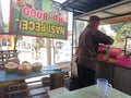 Batu City, East Java, Indonesia. October 2,2023:The man selling young coconut iced drinks is preparing an order