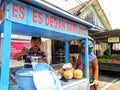 Batu City, East Java, Indonesia . October 24,2023 : the young coconut ice seller is preparing the order