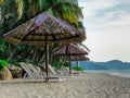 Batu Ferringhi beach, Penang, Malaysia, Sunbeds, palms, sea, ocean, mountains, sand Royalty Free Stock Photo