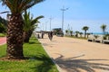 Embankment of Batumi with alley of palm trees, bicycle path and modern architecture Royalty Free Stock Photo