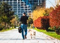 Batumi, Georgia - April, 09 2019. A man and his dog for a walk in the park.