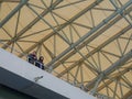 Arch of the stadium. Engineering design. Part of the roof of the stadium. Rain canopy in a modern stadium. People under the