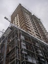 Construction of a concrete house. Modern buildings. Scaffolding. Industrial background