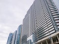 Construction of a concrete house. Modern buildings. Scaffolding. Industrial background. Glazing of a high-rise building