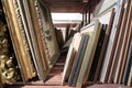 Wooden shelves at art gallery storage full of pictures