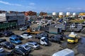 BATUMI, GEORGIA - JUNE 29, 2023: Parking lot with cargo and passenger vehicles near the port structures on the Black Sea coast in