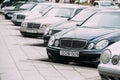 Mercedes-Benz E-Class W210 And W211 Cars Parked In Row In Street on Summer Day