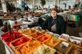 Elderly Georgian Woman, Seller Of Spices Is Waiting For Buyers At The Counter