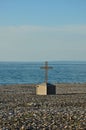 Christian cross crucifix on rocky Black Sea beach seafront Batumi Georgia Royalty Free Stock Photo