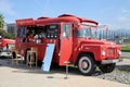 Batumi, Georgia - October 6, 2023: food truck, red old retro school bus, used as coffee shop adapted for the sale of fast food, Royalty Free Stock Photo