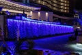 Night view of hotel Palm apartments waterfall illuminated by colorful lights in Batumi city - the capital of Adjara in Georgia Royalty Free Stock Photo