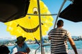 Batumi, Georgia- 26th july, 2022: boat driver with assistant and tourist in boat prepara parachute fro para sailing in summer