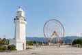 Batumi Lighthouse and Ferris wheel are stand on the embankment of Batumi city - the capital of Adjara in Georgia