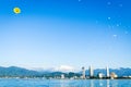 BAtumi panorama with parasailers mid-air in yellow parachute in clear blue sky day. Couple do para sailing touch water.Para-