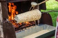 traditional way of Baumkuchen baking on open fire Royalty Free Stock Photo