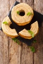 Baumkuchen, translated as tree cake, is a many-layered sponge cake baked on a rotating cylinder close-up. Vertical top view Royalty Free Stock Photo