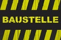 Baustelle in German, construction site warning sign with yellow and black stripes Royalty Free Stock Photo