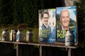 In Bavaria, CSU election posters stand in the countryside between old milk cans. The milk cans are made of metal and some are