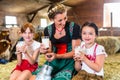 Bavaria family drinking milk in cow barn Royalty Free Stock Photo