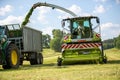 Claas Jaguar 930 harvester and a John Deere 6175R with a Fliegl Gigant trailer works on a