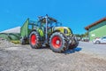 Claas tractor with a loader wagon, working on a biogas plant