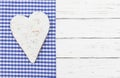 Bavarian background with white wooden heart on blue checked fabric border and white wood Royalty Free Stock Photo