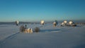 Bavarian church and radio telescopes of Raisting with snow during winter and sunset from above