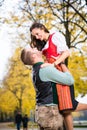 Bavarian couple in Tracht in loving embrace with uplift Royalty Free Stock Photo