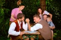 Bavarian family sitting outdoors at beer garden having fun Royalty Free Stock Photo