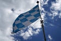 Bavarian flag flies against a blue white sky on a summer day in Bavaria Royalty Free Stock Photo