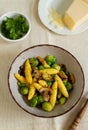 Bavarian fried finger-shaped potato dumplings with green vegetables and mushrooms