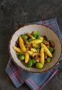 Bavarian fried finger-shaped potato dumplings with green vegetables and mushrooms