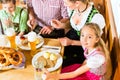 Bavarian girl with family in restaurant Royalty Free Stock Photo