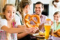 Bavarian girl with family in restaurant Royalty Free Stock Photo