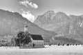 Bavarian landscape - view of the church of St. Coloman on the background of the Alpine mountains and Neu