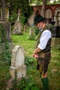 Bavarian man standing in front of grave Royalty Free Stock Photo